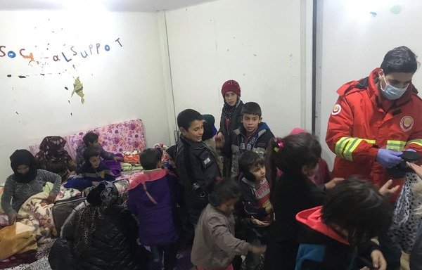 Basmeh and Zeitooneh workers distribute aid to Syrian refugee families at one of their centres in Lebanon. [Photo courtesy of Basmeh and Zeitooneh]