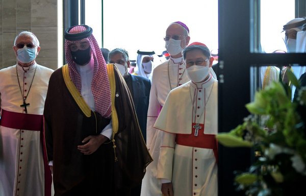 Cardinal Luis Antonio Tagle (R) and sheikh Abdullah bin Hamad Al-Khalifa (C) arrive at Our Lady of Arabia Cathedral ahead of its opening in Awali, south of Manama, on December 9. The church is the largest Roman Catholic cathedral in the Arabian Peninsula. [Mazen Mahdi/AFP]