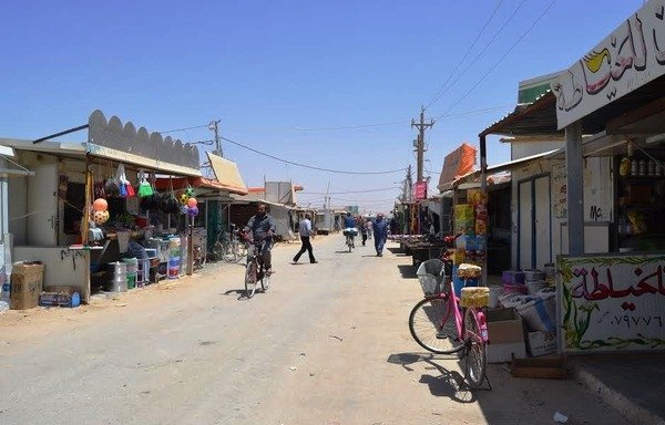 Syrian refugees ride bicycles inside Jordan's sprawling Zaatari camp. [Mohammad Ghazal/Al-Mashareq]
