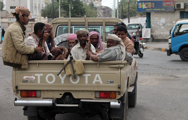 Yemeni tribesmen from Shabwa province sit in the back of a pick-up truck in the southern city of Aden on March 23rd, 2015. [Saleh al-Obeidi/AFP]