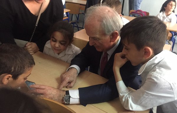 Lebanese Education Minister Marwan Hamadeh assists children with a new educational app at the Uruguay Public School in Ashrafieh. [Nohad Topalian/Al-Mashareq]