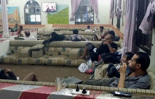 During the holy Muslim fasting month, Yemenis gather in public places to watch Ramadan television programmes broadcast on big screens. [Faisal Darem/Al-Mashareq]