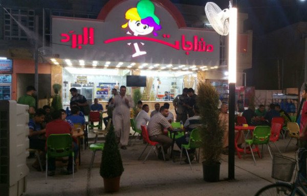 A crowd of Iraqis gathers at a Fallujah ice cream shop after iftar.