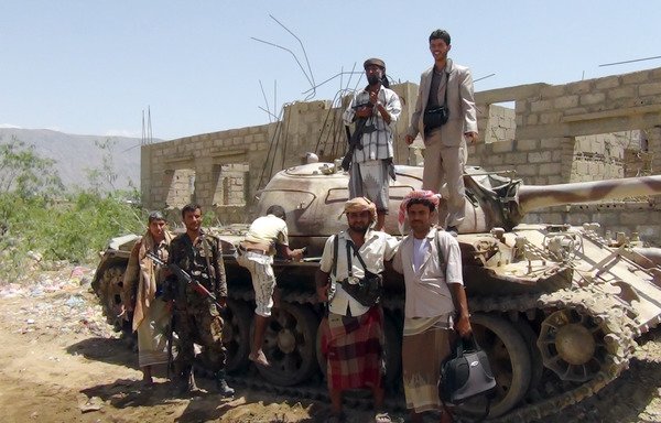 Yemeni soldiers pose with supporters from local tribes during a search for al-Qaeda elements in the Abyan province town of Loder on April 25th, 2012. The Interior Ministry recently announced it is recruiting 3,000 members of the tribal popular committees into the Yemeni forces. [AFP PHOTO/STR]