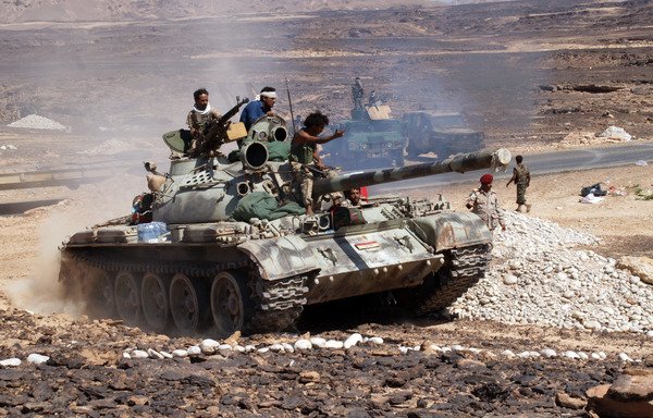 Yemeni soldiers ride a tank in this file photo from May 8th, 2014, after they seized control of Azzan, a key al-Qaeda stronghold in Shabwa province. [Stringer/AFP]