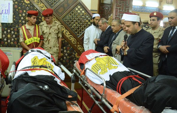 Egyptian clerics pray over the bodies of soldiers, who were killed a day earlier in the restive Sinai Peninsula in an attack by the 'Islamic State of Iraq and Syria', during a funeral ceremony in the city of al-Mansurah on July 8th. [Ahmad Hammad/AFP]