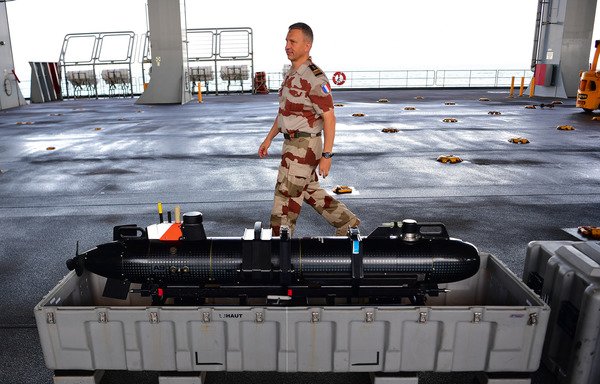 A French officer walks past a submarine Sonar device used on the Lewis B. Puller carrier during a joint de-mining drill between the US, British and French navies in the Arabian Gulf on April 15th. [Giuseppe Cacace/AFP]