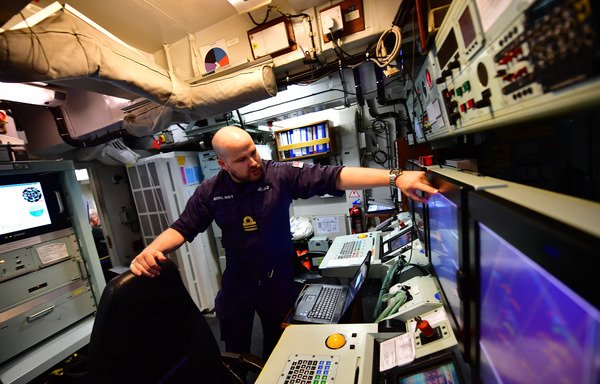 An officer works on board of the HMS Ledbury ship during a joint de-mining drill between the US, British and French navies in the Arabian Gulf on April 15th. [Giuseppe Cacace/AFP]