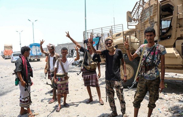 Fighters of the UAE-trained Security Belt Forces, dominated by members of the Southern Transitional Council (STC) which seeks independence for south Yemen, gather at the al-Alam crossroads on the eastern entrance of Aden on August 30th. [Nabil Hasan/AFP]