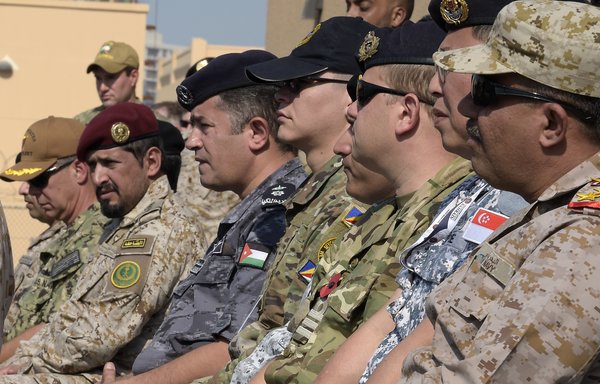 Coalition soldiers in the International Maritime Security Construct (IMSC) attend the opening ceremony at the US 5th Fleet Command in the Bahraini capital Manama on November 7th. [Mazen Mahdi/AFP]