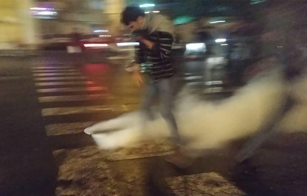 یک معترض ایرانی برای جلوگیری از تماس با گاز اشک آور درتظاهرات ۱۶ نوامبر علیه افزایش قیمت بنزین در تهران صورت خود را پوشانده است. [خبرگزاری فرانسه]