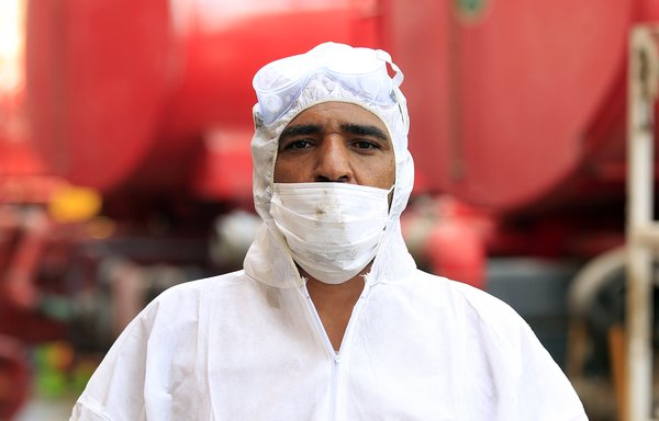 Khaled Abdullah al-Redy, a member of the Yemeni Civil Defence, dons personal protective equipment amid the coronavirus pandemic at the group's headquarters in Sanaa on April 12th. [Mohammed Huwais/AFP]
