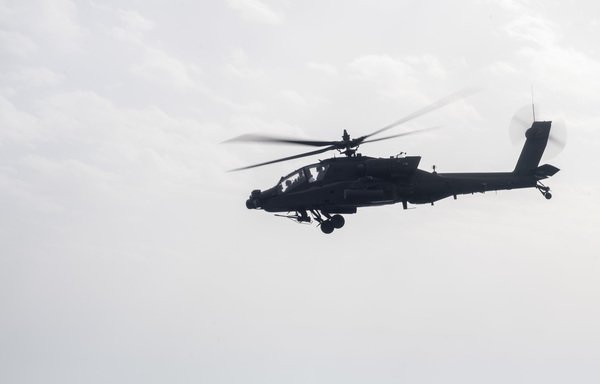 An Apache helicopter flies over Gulf waters during recent US military exercises. [US Navy]