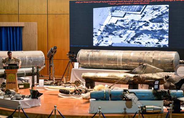 Royal Saudi Air Force Col. Turki al-Maliki gives a press conference at the Armed Forces Officers club in Riyadh July 2nd, alongside showcased alleged Iranian weapons seized by Saudi forces from Yemen's Houthis. [Fayez Nureldine/AFP]