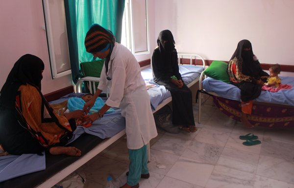 A medic examines a Yemeni child suffering from malnutrition at a treatment centre in Yemen's northern Hajjah province on July 5th. [Essa Ahmed/AFP]