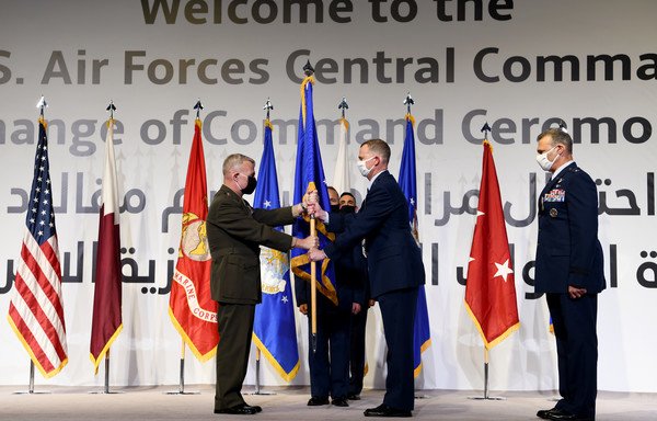 US Marine Corps Gen. Kenneth McKenzie, commander of CENTCOM, presents the guidon to US Air Force Lt. Gen. Gregory Guillot, incoming commander of US Air Forces Central Command, during a change of command ceremony at al-Udeid air base, Qatar, July 16th. [Photo courtesy of US Air Force]