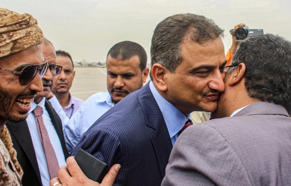 Ahmed Lamlas, the new governor of Aden, embraces a man at Aden International Airport on August 27th. [Saleh al-Obeidi/AFP]