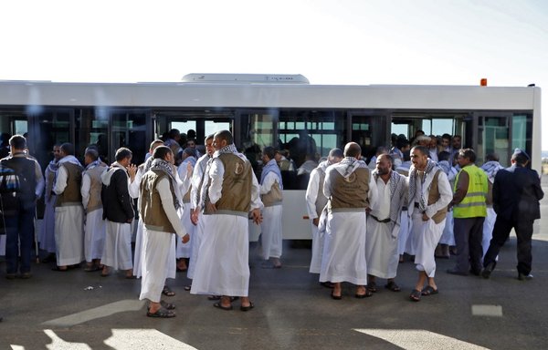 Yemeni Houthi prisoners are pictured upon their arrival at Sanaa airport, following their release by the Arab coalition, on November 28th, 2019. [Mohammed Huwais/AFP]