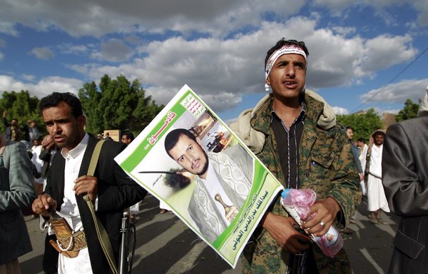 A supporter of the Houthis holds a portrait of militia leader Abdul-Malik al-Houthi during a protest in Sanaa on September 11th, 2015. [Mohammed Huwais/AFP]