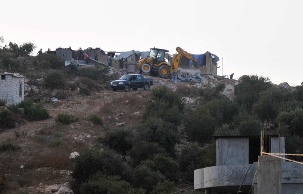 Lebanon's Internal Security Forces demolish a house where suspected ISIS elements were hiding in the northern Wadi Khaled region near the border with Syria on September 27th. [Ibrahim Chalhoub/AFP]