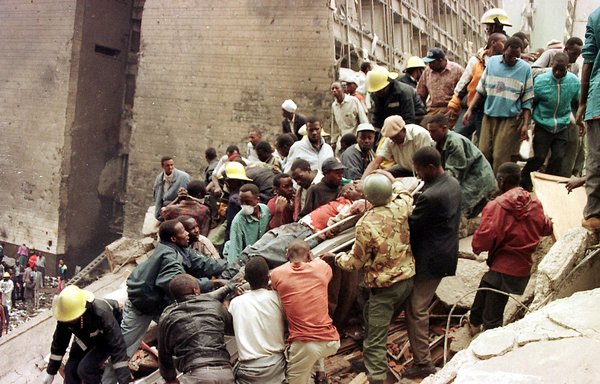 Civilians and firemen work to remove corpses after a bomb exploded near the US Embassy in Nairobi, Kenya, in 1998, killing at least 60 people including eight Americans and leaving more than 1,000 injured. [AFP]