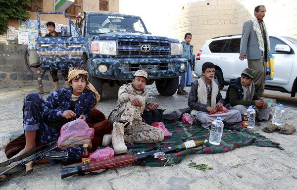 A group of Houthis and their supporters chew qat in Sanaa in 2015. [Mohammed Huwais/AFP]