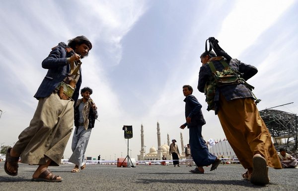 Fighters aligned with the Houthis stand guard in Sanaa on September 24th. [Mohammed Huwais/AFP] 