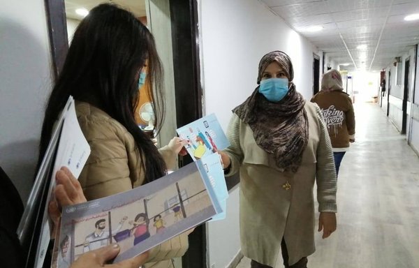 Government employees take part in a Labour Ministry campaign to educate them about the dangers of COVID-19 on December 7. [Iraqi Ministry of Labour]