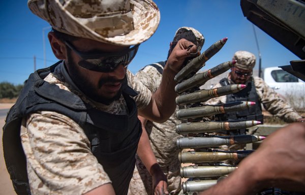 Fighters hold a position during clashes with forces loyal to Libyan strongman Khalifa Haftar. For years Haftar has been backed by Moscow and its Wagner Group mercenaries. [Fadel SENNA / AFP]