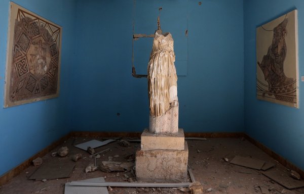 A beheaded and mutilated statue is seen in the destroyed museum in the ancient city of Palmyra on March 31, 2016. ISIS destroyed priceless heritage at the UNESCO-listed site on the grounds that it was idolatrous. [Joseph Eid/AFP]