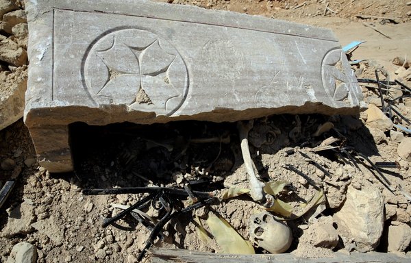 A picture shows the destroyed stone sarcophagus of Syriac Catholic Saint Elian at the entrance to his monastery in the town of al-Qaryatain in Homs province on April 4, 2016, after Syrian regime forces regained control of the town from ISIS. [Joseph Eid/AFP]