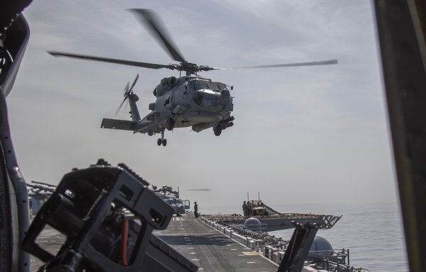 An MH-60R Sea Hawk helicopter takes off from the flight deck of the USS Makin Island during a Strait of Hormuz transit on February 8. [US Naval Forces Central Command]