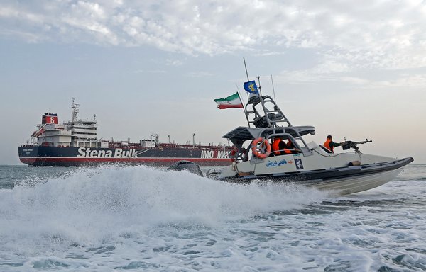 A picture taken on July 21, 2019, shows the IRGC patrolling around the seized British-flagged tanker Stena Impero as it is anchored off the Iranian port city of Bandar Abbas. [Hasan Shirvani/Mizan News Agency/AFP]