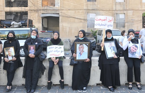 Families of the victims of the Beirut port explosion hold a vigil at the port's main entrance on July 4. Some held banners that demanded that those who were responsible be brought to justice. [Ziad Hatem]