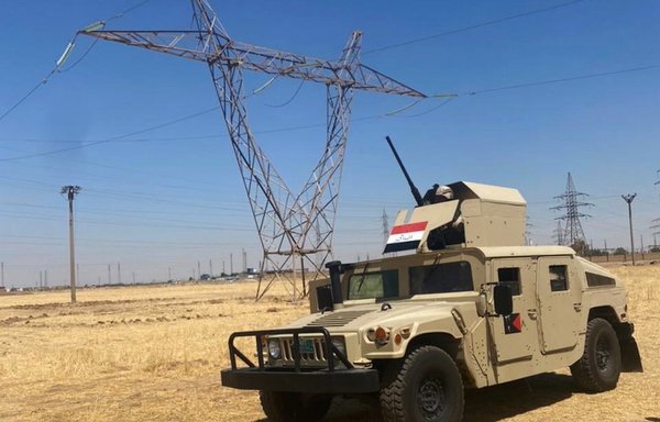 An Iraqi army vehicle can be seen deployed near a power transmission tower in this photo posted on August 1. [Iraqi Ministry of Defence]