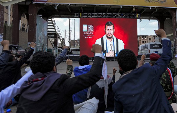 Supporters of the Houthis attend a speech given onscreen by the group's leader, Abdul-Malik al-Houthi, during a rally in Sanaa on August 19. [Mohammed Huwais/AFP]