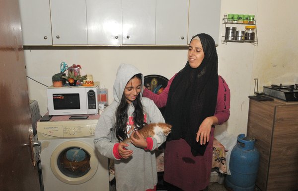 Laila Khalil and her family live in a modest room in the Beirut suburb of al-Nabaa. Her 11-year-old daughter, Remas, had been looking forward to attending school, but the cost of transportation has kept her home. [Ziad Hatem]