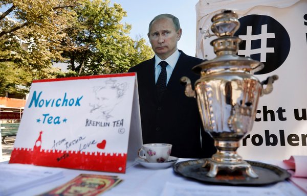 A mock offer of 'Novichok Tea' is seen in front of an effigy of Russian President Vladimir Putin outside the Russian embassy in Berlin during a September 23, 2020, protest. [Odd Andersen/AFP]