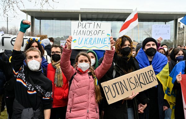 People protest against Russia's invasion of Ukraine on February 24 in Berlin. [John MacDougall/AFP]