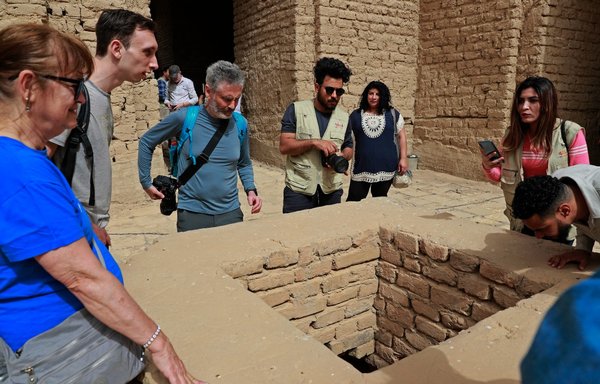 سائحون أجانب يزورون مدينة بابل الأثرية الواقعة على بعد مائة كيلومتر جنوبي بغداد، في 7 آذار/مارس. [أحمد الرباعي/ وكالة الصحافة الفرنسية]