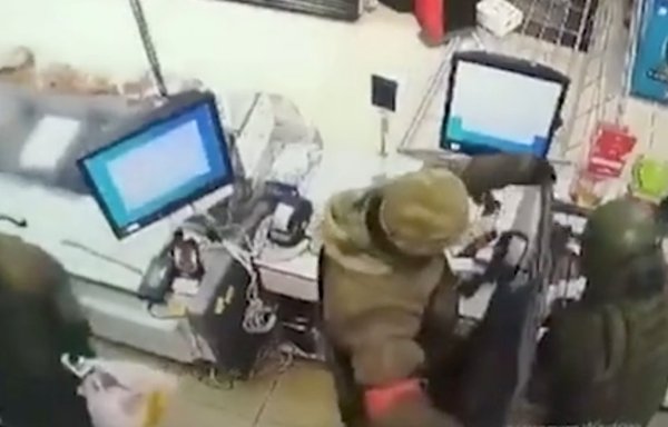 An undated screenshot from a Ukrainian security camera shows Russian troops looting a convenience store. [File]