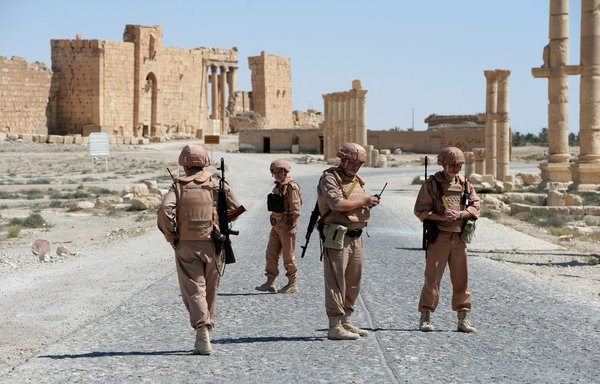Russian army soldiers patrol the ancient Syrian city of Palmyra in 2016. The ancient city was looted of some of its riches by Russian soldiers and Wagner mercenaries. [Vasily Maximov/AFP]