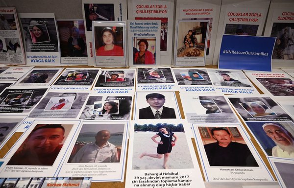 Uighurs present pictures of their relatives detained in China during a press conference in Istanbul on May 10. [Ozan Kose/AFP]