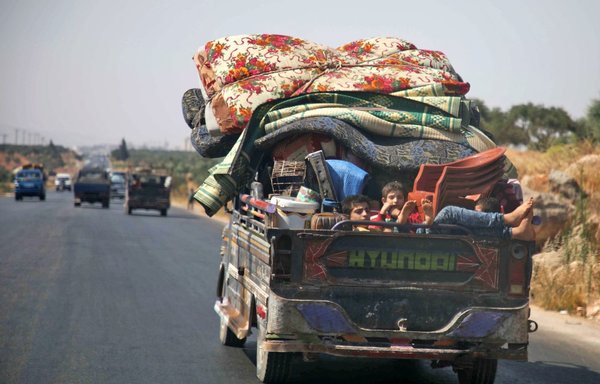 Some Syrian families say they have left their villages under Iranian control in order to protect their womenfolk from Hizbullah and IRGC elements. In this photo taken August 4, 2019, displaced Syrians flee from their villages in the south of Idlib province. [Aaref Watad/AFP]