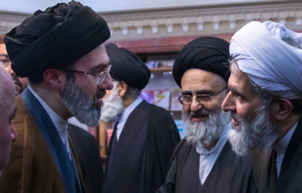 Hossein Taeb (right) speaking with Iranian leader Ali Khamenei's son Mojtaba (left) in an undated photo. [Independent Persian]