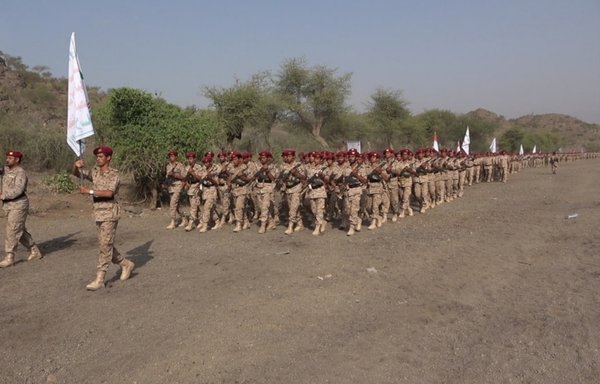 Newly trained Houthi fighters march in formation during a June 27 graduation ceremony in Yemen. [Houthi-affiliated SABA News Agency]