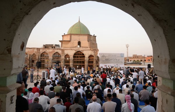 Muslims gather to pray in the courtyard of Mosul's famed al-Nouri mosque during Eid al-Adha, on July 9. [Zaid al-Obeidi/AFP]