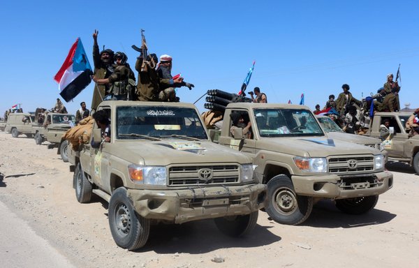 Yemeni pro-government fighters from the UAE-trained Giants Brigade gather on the outskirts of Ataq city, east of the Red Sea port of Aden, on their way to the frontline facing pro-Iran Houthi fighters, on January 28. [Saleh al-Obeidi/AFP]