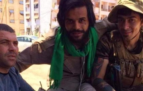 A Fatemiyoun Division element (centre) poses with two Iraqi militiamen in Daraa city in a photo posted August 25. [Mohammad Asakra Twitter account]