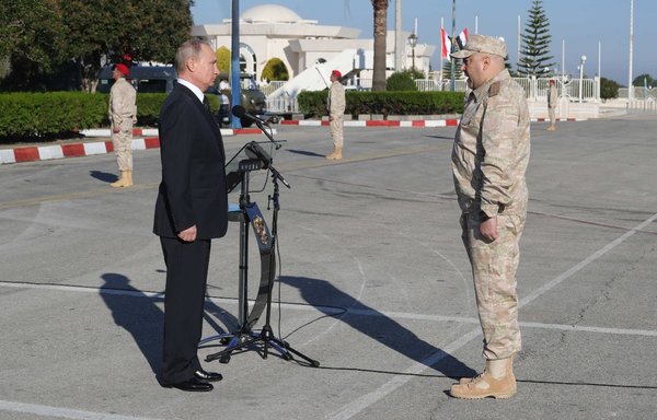 In a picture taken December 11, 2017, Russian President Vladimir Putin listens to Col. Gen. Sergei Surovikin, then commander of Russian troops in Syria, while visiting the Russian air base in Hmeimim in the Syrian province of Latakia. [Mikhail Klimentyev/Sputnik/AFP]